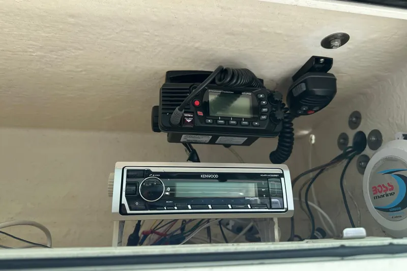 Slide: The Image of 2008 Dusky 278 Center Console boat electronics, featuring Kenwood and Standard Horizon devices. - 17