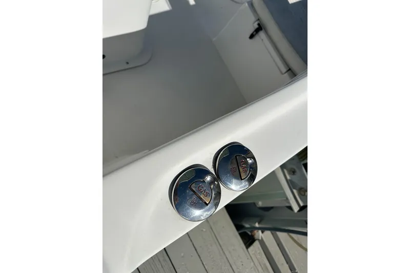 Slide: The Image of Chrome fuel caps on 2008 Dusky 278 Center Console boat deck. - 18