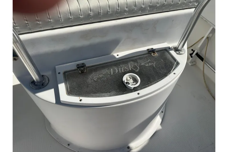 Slide: The Image of 2008 Dusky 278 Center Console boat dashboard with logo and storage compartment. - 20