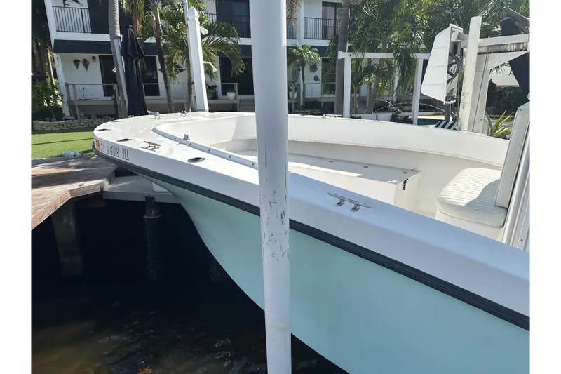 Slide: The Image of 2008 Dusky 278 Center Console boat docked near waterfront property. - 25