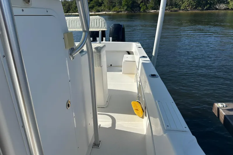 Slide: The Image of 2008 Dusky 278 Center Console boat docked on calm water, featuring spacious deck. - 31