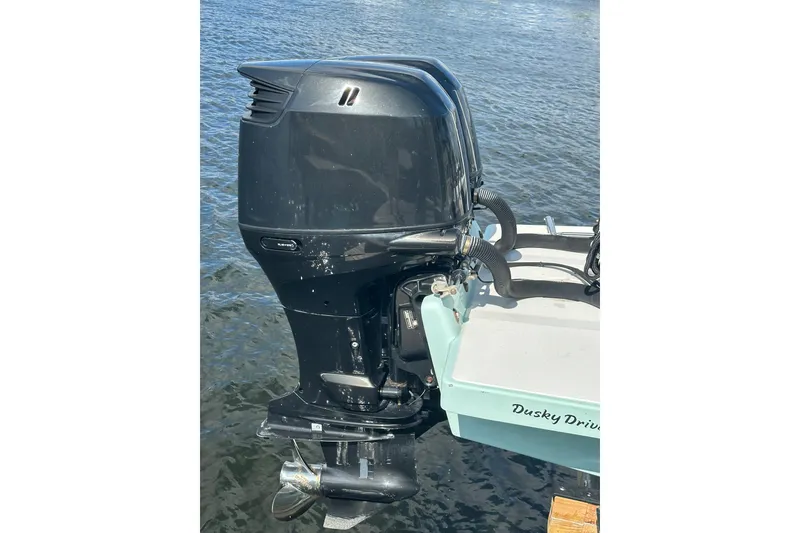 Slide: The Image of 2008 Dusky 278 Center Console boat with powerful outboard motor on water. - 34