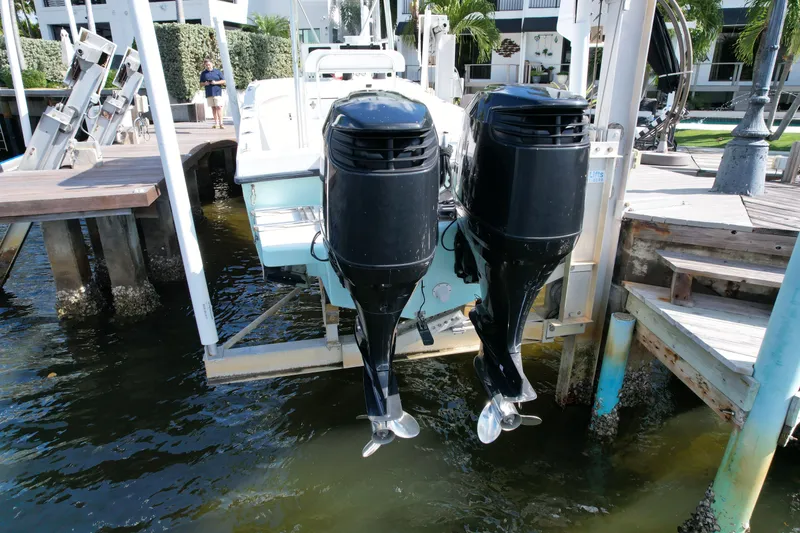 Slide: The Image of 2008 Dusky 278 Center Console boat with dual outboard motors on a lift. - 36