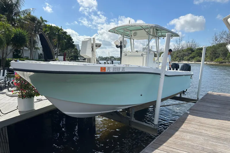 Slide: The Image of 2008 Dusky 278 Center Console boat docked by a scenic waterfront. - 38