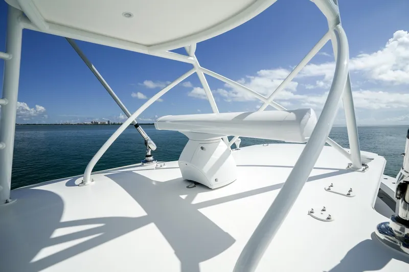 Slide: The Image of 2024 SeaVee 400Z helm with steering wheel and controls on turquoise water. - 11