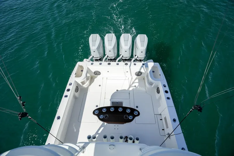 Slide: The Image of 2024 SeaVee 400Z boat with four powerful outboard engines on turquoise water. - 12