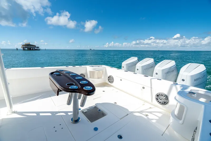 Slide: The Image of 2024 SeaVee 400Z boat with multiple engines, ocean view, and fishing setup. - 15