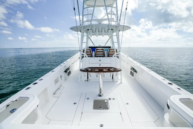 Slide: The Image of 2024 SeaVee 400Z boat deck with ocean view, featuring fishing equipment and seating. - 2