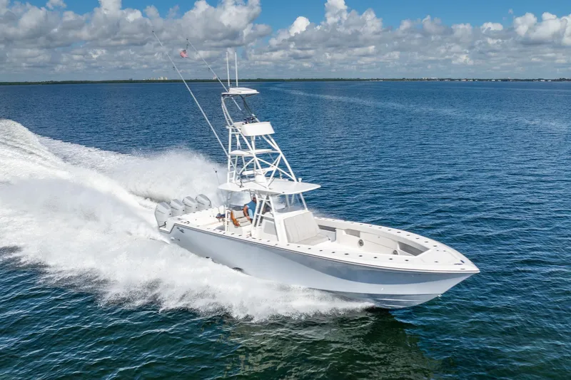 Slide: The Image of 2024 SeaVee 400Z boat cruising on open ocean under clear blue sky. - 22