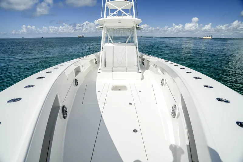 Slide: The Image of 2024 SeaVee 400Z boat on calm ocean, clear sky, spacious deck. - 6