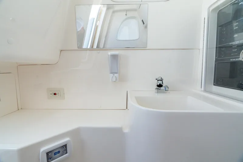 Slide: The Image of 2024 SeaVee 400Z boat interior with sink, mirror, and control panel. - 7