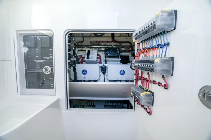 Slide: The Image of 2024 SeaVee 400Z electrical panel with organized wiring and switchboard. - 9