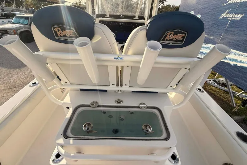 Slide: The Image of 2019 Ranger 2510 Bay Ranger boat interior with rod holders and seating. - 8