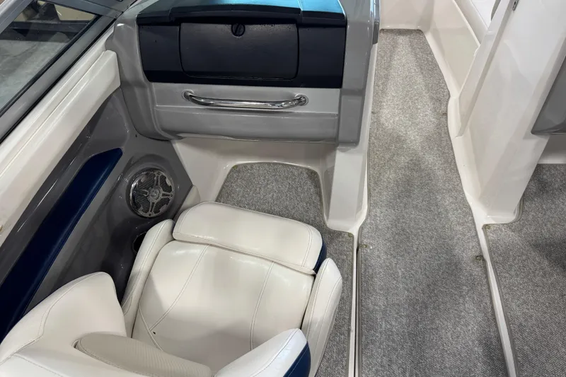 Slide: The Image of 2012 Chaparral 216 SSi boat interior with white seating and gray carpet. - 17