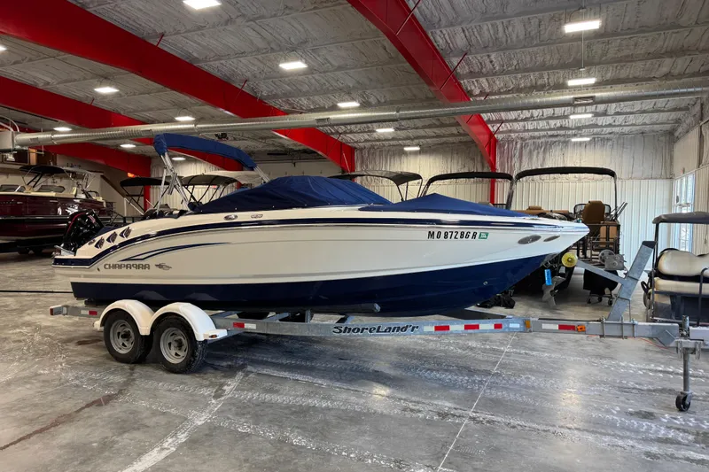 Slide: The Image of 2012 Chaparral 216 SSi boat on trailer in indoor storage facility. - 22