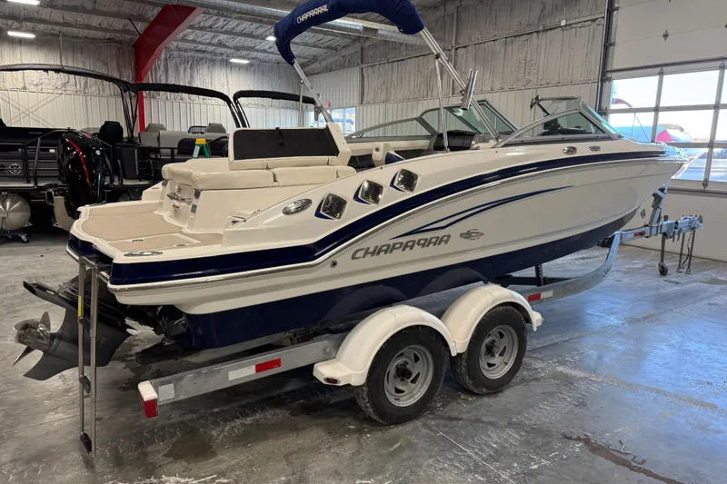 Slide: The Image of 2012 Chaparral 216 SSi boat on trailer in indoor storage facility. - 4