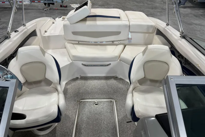 Slide: The Image of 2012 Chaparral 216 SSi boat interior with white seating and carpeted floor. - 6