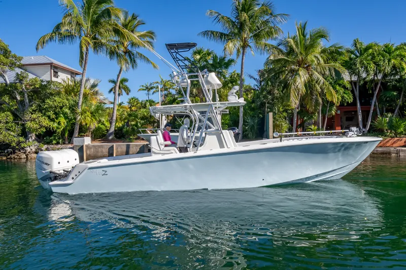 The Image of 2019 SeaVee 340Z boat on tropical water, surrounded by palm trees. - 0