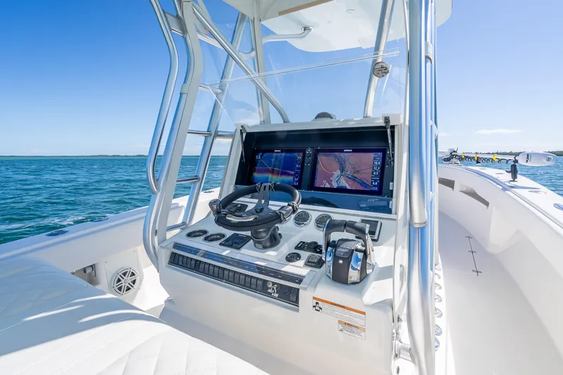 Slide: The Image of 2019 SeaVee 340Z boat console with dual navigation screens on open water. - 10