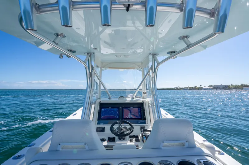 Slide: The Image of 2019 SeaVee 340Z boat interior with navigation screens, steering wheel, and ocean view. - 11