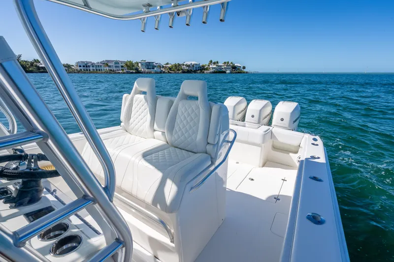 Slide: The Image of 2019 SeaVee 340Z boat with luxurious seating and multiple engines on open water. - 13