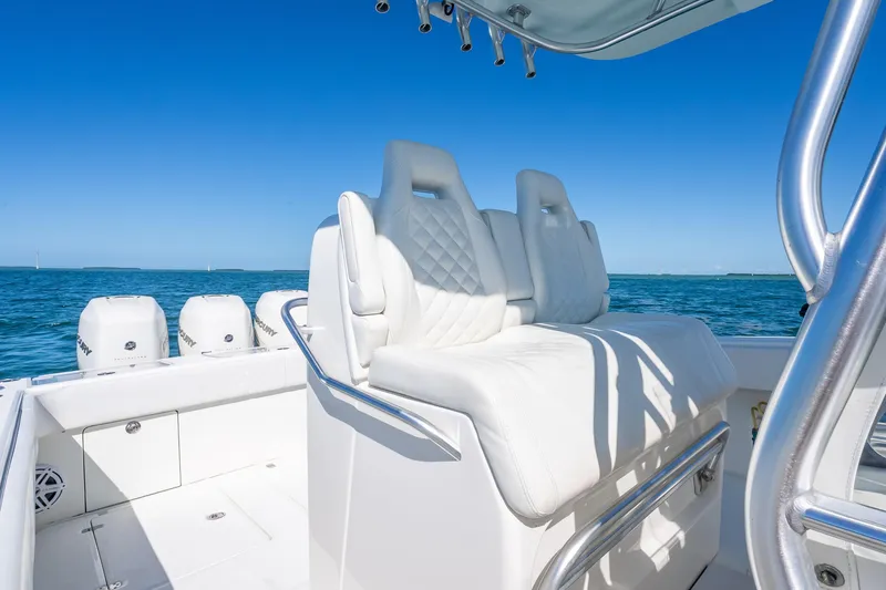 Slide: The Image of 2019 SeaVee 340Z boat with white seating and multiple outboard engines on open water. - 14