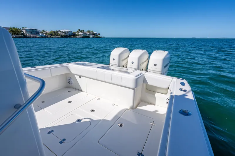Slide: The Image of 2019 SeaVee 340Z boat with triple Mercury engines on open water. - 17