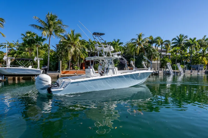 Slide: The Image of 2019 SeaVee 340Z boat docked in tropical marina with palm trees. - 2