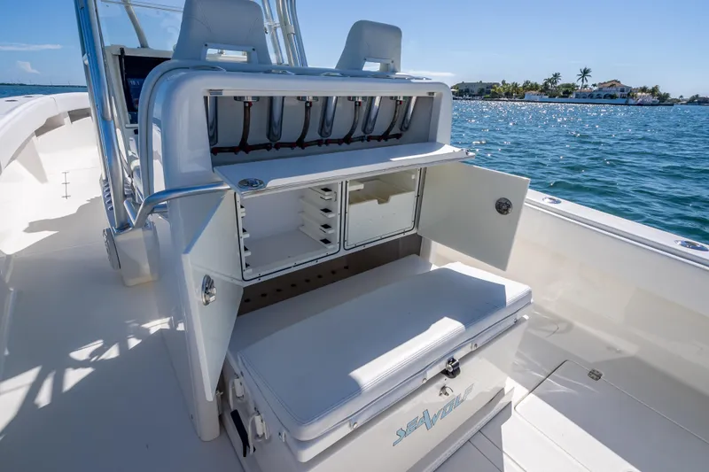 Slide: The Image of 2019 SeaVee 340Z boat with open storage compartments, on a sunny day by the water. - 24