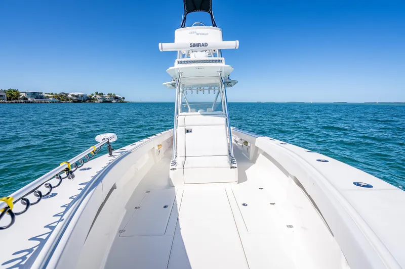 Slide: The Image of 2019 SeaVee 340Z boat on open water, clear blue sky, and coastal view. - 26