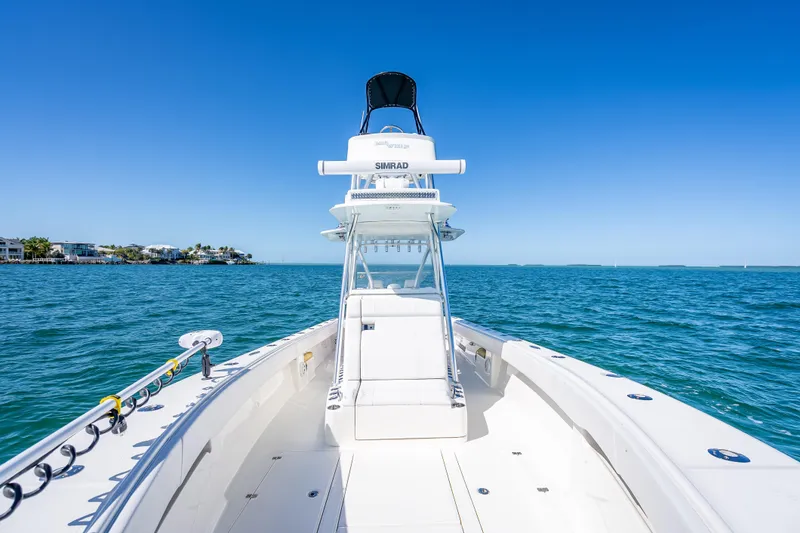 Slide: The Image of 2019 SeaVee 340Z boat on open water under clear blue sky. - 27