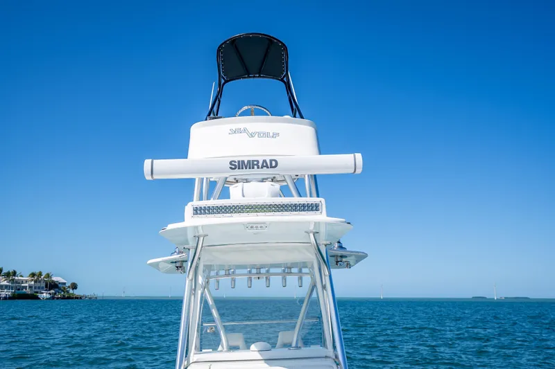 Slide: The Image of 2019 SeaVee 340Z boat with Simrad equipment on open water under clear blue sky. - 32