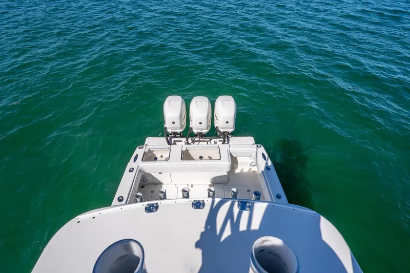 Slide: The Image of 2019 SeaVee 340Z boat with triple outboard engines on open water. - 33