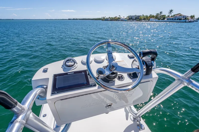 Slide: The Image of 2019 SeaVee 340Z boat helm with steering wheel and navigation equipment on open water. - 35