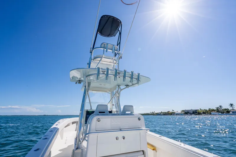 Slide: The Image of 2019 SeaVee 340Z boat on sunny ocean, clear blue sky, and distant shoreline. - 38