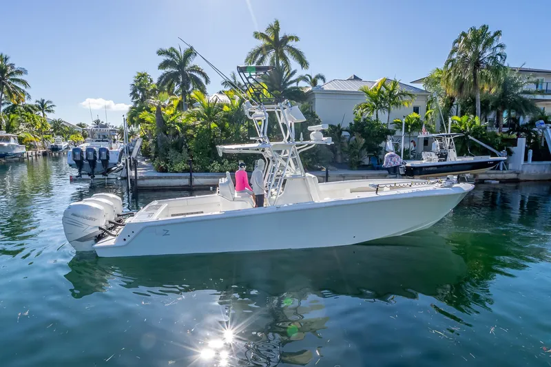 Slide: The Image of 2019 SeaVee 340Z boat cruising in a tropical canal with palm trees. - 4