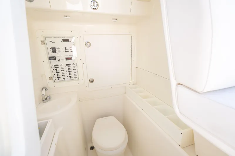 Slide: The Image of 2019 SeaVee 340Z boat interior with control panel and compact bathroom amenities. - 42