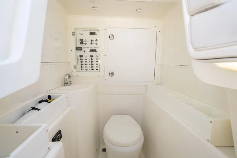 Slide: The Image of 2019 SeaVee 340Z boat interior with toilet and control panel. - 43