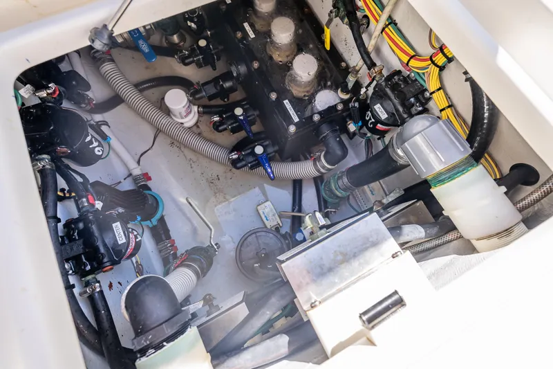 Slide: The Image of 2019 SeaVee 340Z boat engine compartment with hoses and wiring. - 44