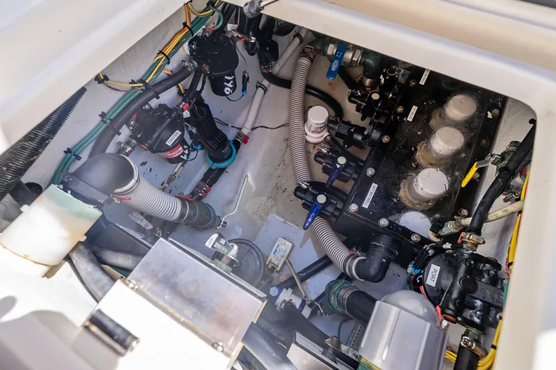 Slide: The Image of Engine compartment of a 2019 SeaVee 340Z boat, showcasing mechanical components and wiring. - 46