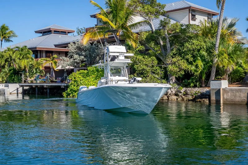 Slide: The Image of 2019 SeaVee 340Z boat near tropical waterfront home with lush greenery. - 5