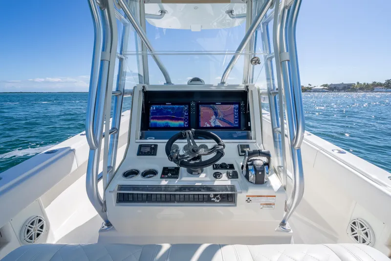 Slide: The Image of 2019 SeaVee 340Z boat helm with navigation screens on open water. - 9