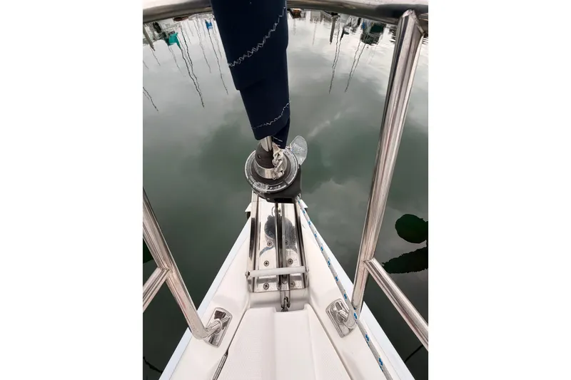 Slide: The Image of Bow of 2009 Hunter 38 sailboat with stainless steel railing and calm water reflection. - 12