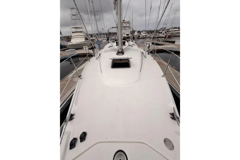 Slide: The Image of 2009 Hunter 38 sailboat deck view at marina, overcast sky. - 13