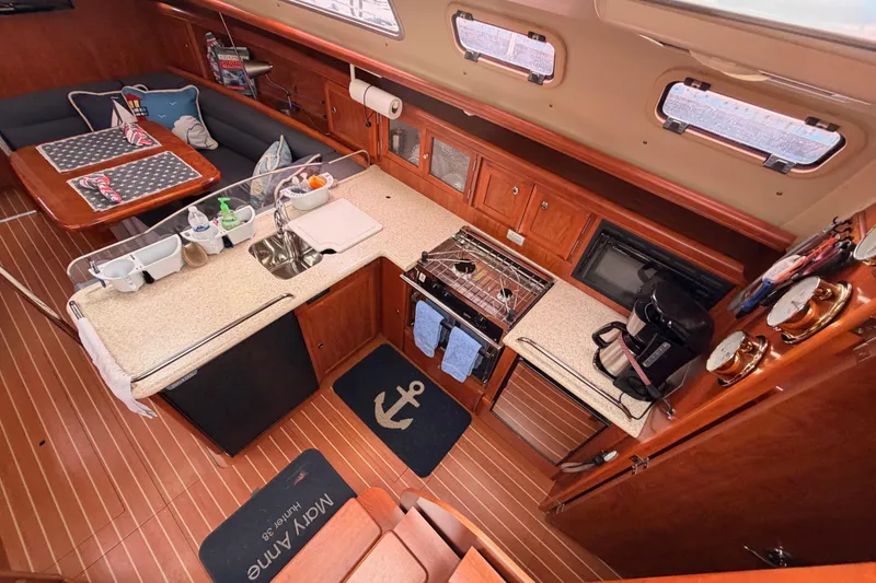 Slide: The Image of Interior of 2009 Hunter 38 sailboat galley with wood finish and modern amenities. - 20