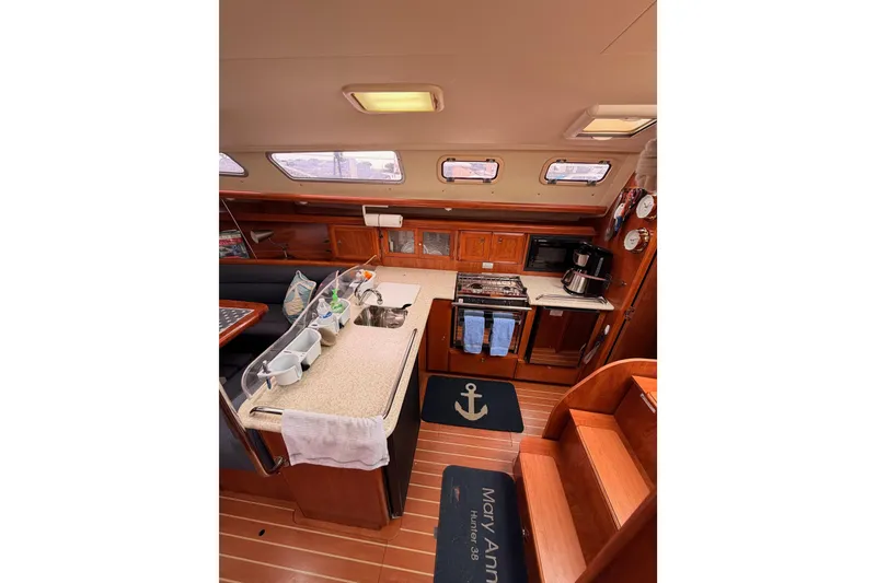 Slide: The Image of Interior of 2009 Hunter 38 sailboat kitchen with wooden cabinetry and modern appliances. - 22