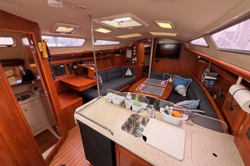 Slide: The Image of Interior of 2009 Hunter 38 sailboat with cozy seating, kitchenette, and modern amenities. - 28