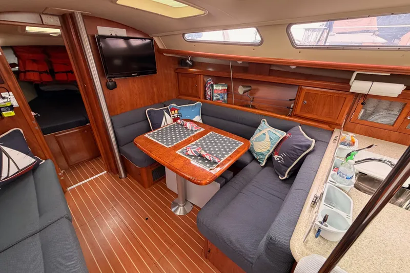 Slide: The Image of Interior of 2009 Hunter 38 sailboat with cozy dining area and nautical decor. - 35