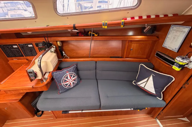 Slide: The Image of Cozy interior of 2009 Hunter 38 sailboat with nautical-themed cushions and wooden cabinetry. - 37