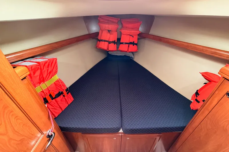 Slide: The Image of 2009 Hunter 38 yacht cabin with life jackets and cozy bedding. - 40